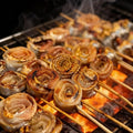 Rolled hairtail pieces grilled on charcoal skewers
